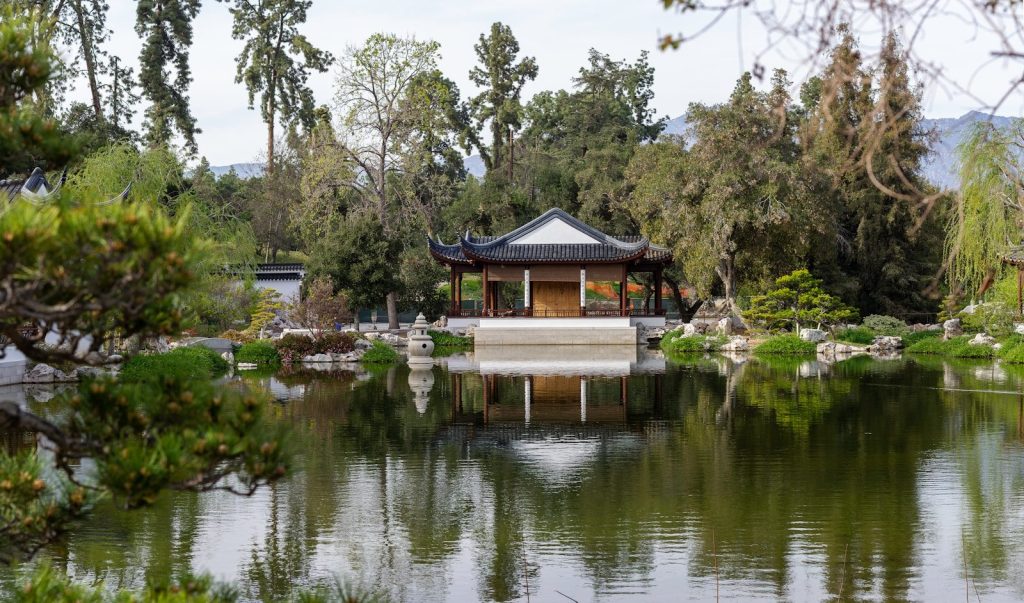a pond with a pavilion in the middle of it