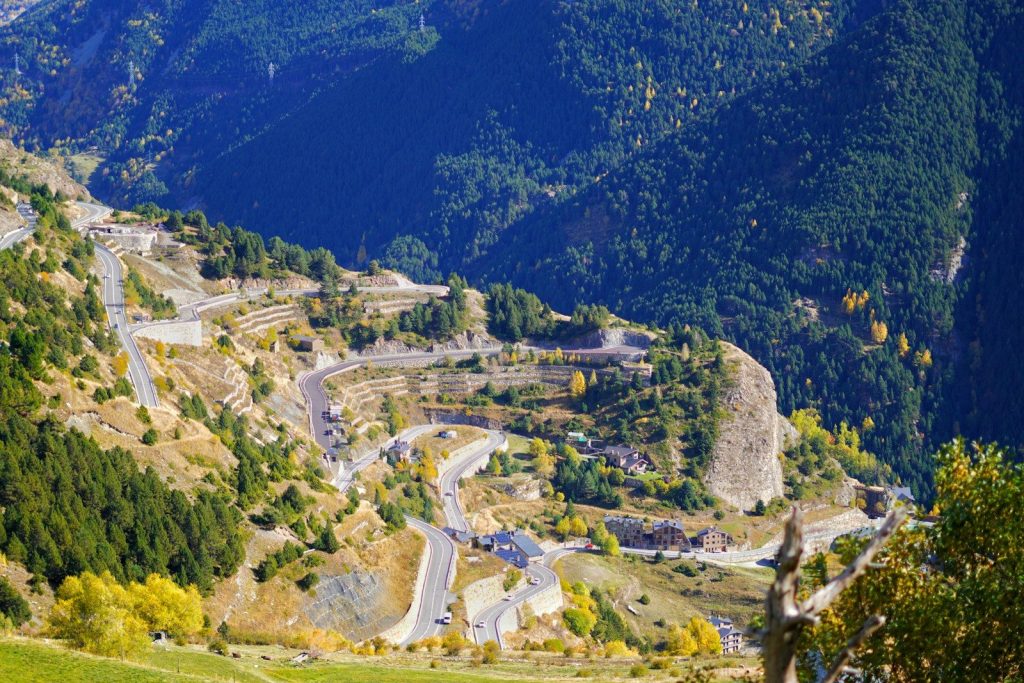 a scenic view of a winding road in the mountains